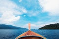 Front view boat floating on blue ocean