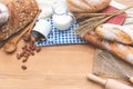 Front view of bread bun, milk, almonds and fresh milk on wooden table. Breakfast preparation, daily product Royalty Free Stock Photo