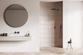 Front view on bright bathroom interior with large round mirror Royalty Free Stock Photo