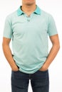 Front view of brown skin male model wear a blue artic shirt with short sleeve with both hands in the pocket Royalty Free Stock Photo