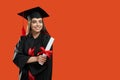 Brunette girl standing with crossed hands, holding diploma. Royalty Free Stock Photo