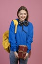 Brunette schoolgirl standing, looking at camera, smiling. Royalty Free Stock Photo