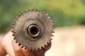 Front view of a camshaft and its gear held in hand, Part of a diesel engine after disassembling Royalty Free Stock Photo
