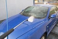 Front view of a car in car wash while cleaning