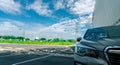 Front view of car parked at parking lot. Shopping mall outdoor car parking area with electric cable line and high voltage electric Royalty Free Stock Photo