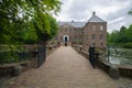 Front view of Castle Arcen and the surrounding water flowers and green nature