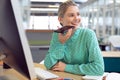 Female graphic designer talking on mobile phone Royalty Free Stock Photo