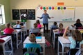 Male school teacher standing in an elementary school classroom Royalty Free Stock Photo