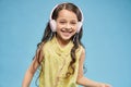 Front view of cheerful girl listening music in headphones Royalty Free Stock Photo