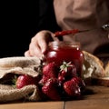 front view chef with jar strawberry jam. High quality photo Royalty Free Stock Photo