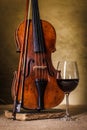 Classical old violin with red wine glass Royalty Free Stock Photo