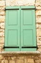 Closed, pair of, colorful, green, wood, window shutters, on house in Sablet, France