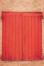 Pair of closed, weathered, colorful, red, wood, window shutters, Sablet, Francepair of,