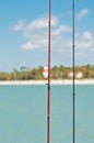 Two fishing rods with fishing lines and a white bobber with orange stripe Royalty Free Stock Photo