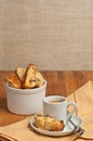 Front view, close up of homemade, freshly baked, apricot walnut biscotti and cup of espresso on a round, small, white saucer with Royalty Free Stock Photo