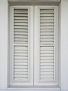 Front view of closed white shutter in Caribbean colonial house. Architecture and construction of the French Antilles. Creole style