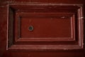 Front view closeup of vintage metallic view finder on blown scratched wooden door texture Royalty Free Stock Photo