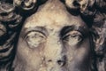 Closeup of woman antique statue face on dark background