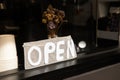 Front view of coffee cafe shop on the roadside shows the open sign. The blurred shadow of barista making the coffee in vintage Royalty Free Stock Photo