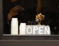 Front view of coffee cafe shop on the roadside shows the open sign. The blurred shadow of barista making the coffee in vintage Royalty Free Stock Photo