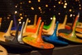 Front view on colorful handmade painted wooden toys - peg tops or whirligigs as creative background with blurred light gold bokeh Royalty Free Stock Photo