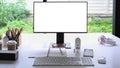 Computer with empty display and office supplies on white table. Royalty Free Stock Photo