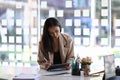 Front view of a confident businesswoman is working on tablet at her workplace in office. Royalty Free Stock Photo