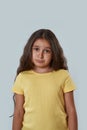 Front view of confused little girl look at camera Royalty Free Stock Photo