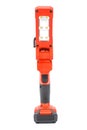Front view of cordless 12V LED task light with flexible head and retractable hook for hands-free lighting in red and black Royalty Free Stock Photo