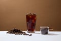 Front view of cup of coffee and coffee beans on brown background. Advertising scene for drink product. Active caffeine in coffee Royalty Free Stock Photo