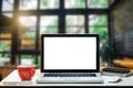 Front view of cup and laptop on table in office room