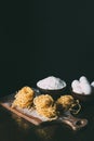 front view of cutting board with raw pasta, bowls with flour and eggs on table