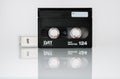 Front view of a DAT cassette with box isolated on white background with reflection Royalty Free Stock Photo