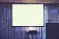 Front view of decorated wedding room with empty white projector screen in the centre. Equipment for video and slideshow projection Royalty Free Stock Photo