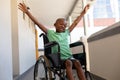 Disabled Schoolboy Arms Stretched Out In A Corridor