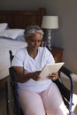 Disabled senior woman using digital tablet in bedroom Royalty Free Stock Photo