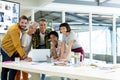 Front view of diverse business people discussing over laptop in the conference room at office Royalty Free Stock Photo