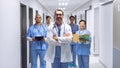 Medical team of doctors looking at camera in corridor at hospital Royalty Free Stock Photo