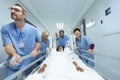 Medical team pushing emergency stretcher bed in corridor Royalty Free Stock Photo