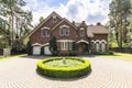 Front view of a driveway with a round garden and big, english st Royalty Free Stock Photo