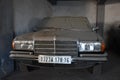 Front view of Dusty forgotten classic mercedes-benz w201 in garage in Algiers, Algeria, November 12, 2017