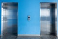 Front view of elevator with blue wall Royalty Free Stock Photo