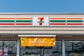 front view of 7-Eleven convenience store logo sign on roof in Nonthaburi, Thailand-December 12, 2023