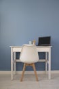 Front view of empty home office of creative entrepreneur with white table during lunch break. Modern creative workspace with black Royalty Free Stock Photo