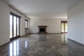 Front view empty living room with fireplace. Interior of empty old villa to be refurbished Royalty Free Stock Photo