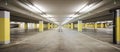 Front view empty underground supermarket parking with yellow concrete columns and white arrow on the ground Royalty Free Stock Photo