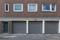 entrance of the building and shutter doors of garages under typical design of housing or apartment in Europe.