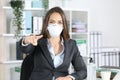 Executive with mask pointing at you at office