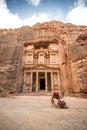 Front view of the famous Al-Khazneh (aka Treasury) with camels resting next to it in the ancient city of Petra