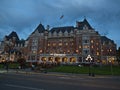 Front view of famous luxury hotel The Fairmont Empress in Victoria downtown at Inner Harbour in the evening with cloudy sky.